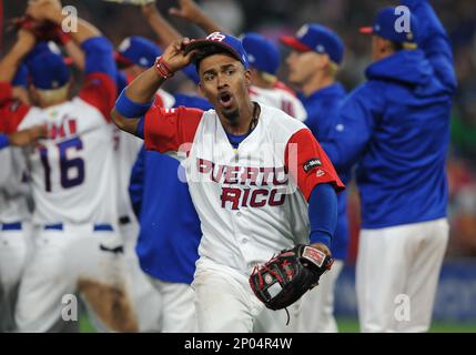 Puerto Rico infielder Francisco Lindor, right, yells after he tagged out  Nicaragua's Juan Diego Montes (99) as Montes tried to steal the second base  during the fourth inning of a World Baseball