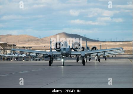 An A-10C Thunderbolt IIs assigned to the 354th Fighter Squadron, Davis-Monthan Air Force Base, Arizona, taxi prior to taking off for a mission during Red Flag 23-1 at Nellis Air Force Base, Nevada, Feb. 6, 2023. Red Flag allows U.S. and coalition forces to train together in high-end, realistic scenarios increasing interoperability of the joint force Stock Photo