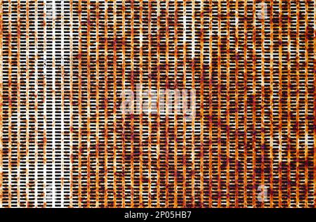 Full frame close-up on a rusty metal plate with rectangular holes all over it. Stock Photo