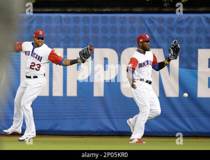 MIAMI, FL - MARCH 11: Dominican Republic outfielder Starling Marte (6) and  Dominican Republic outfielder Nelson Cruz (23) on a fielding error in  center field on a long ball by United States