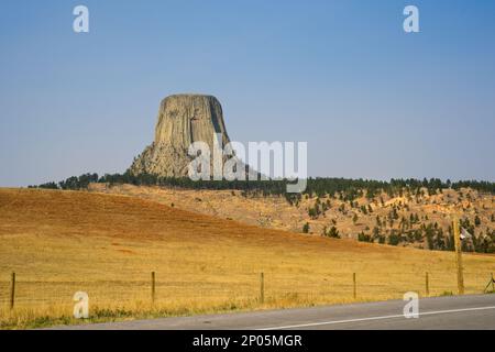 Devils Tower, an ancient volcanic plug, stands alone and majestic in the landscape of eastern Wyoming Stock Photo