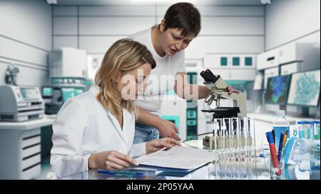 Caucasian female scientists, biologists, biochemists working in research laboratory. Stock Photo