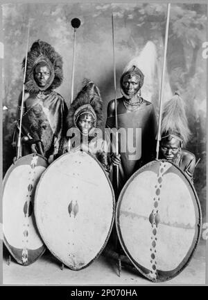 Four masai warriors in full war dress, Kenya. Frank and Frances Carpenter Collection , Published in: 'The World and Its Cultures' chapter of the ebook Great Photographs from the Library of Congress, 2013, Maasai (African people),1890-1930, Warriors,Kenya,1890-1930, Shields,Kenya,1890-1930, Spears,Kenya,1890-1930, Headdresses,1890-1930, Men,Kenya,1890-1930. Stock Photo