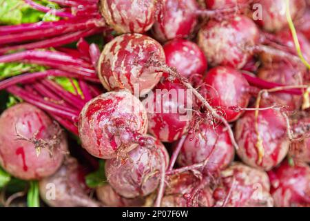 Full frame close-up on a stack of beetroots for sale on a market stall. Stock Photo