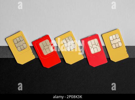 Different SIM cards on color background, flat lay Stock Photo
