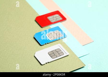 Different SIM cards on color background, closeup Stock Photo