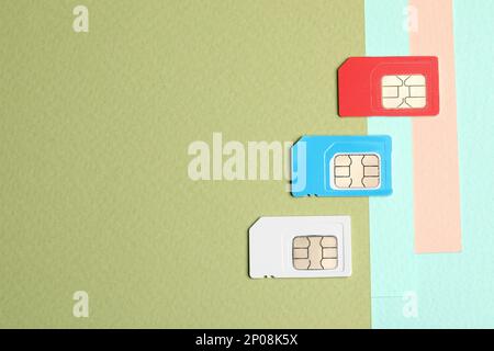 Different SIM cards on color background, flat lay. Space for text Stock Photo