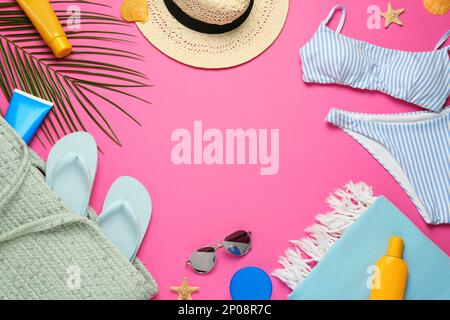 Frame made with different beach objects on pink background, flat lay. Space for text Stock Photo