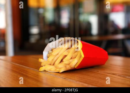 MYKOLAIV, UKRAINE - AUGUST 11, 2021: Big portion of McDonald's French fries on table in cafe Stock Photo