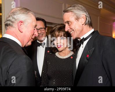 Britain's Prince Charles, left, speaks to actress Joan Collins, centre, and actor Jeremy Irons, right, as he attends the annual Prince's Trust 'Invest In Futures' reception at The Savoy Hotel in London, Thursday, Feb. 9, 2017, where he met the charity's ambassadors, supporters and beneficiaries.(Geoff Pugh/Pool Photo via AP)