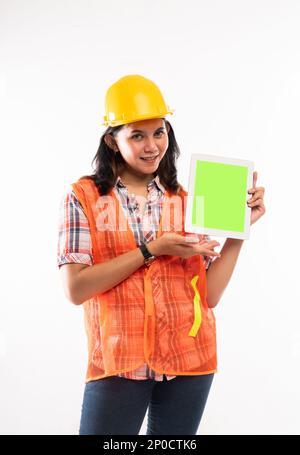 a beautiful architect showing the digital tablet with green screen Stock Photo