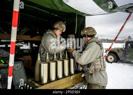 Army Cpl. Brady Kielpikowski and Pfc. Dominic Tilton, 1-120th Field Artillery Regiment, assemble a 105mm High Explosive shell to be used with the M119 howitzer during Northern Strike 23-1, Jan. 23, 2023, at Camp Grayling, Mich. Units that participate in Northern Strike’s winter iteration build readiness by conducting joint, cold-weather training designed to meet objectives of the Department of Defense’s Arctic Strategy. Stock Photo