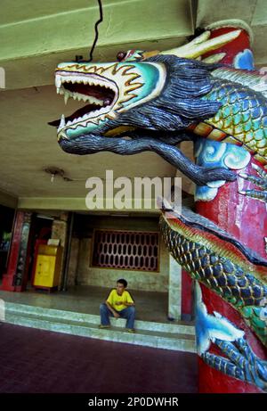 A dragon sculpture is photographed in a background of a man sitting on stairway at Avalokiteshvara Vihara, one of the oldest Chinese temples in Indonesia, which is located in an area called Banten Lama (Old Banten) in Serang, Banten, Indonesia, on this photo taken in 2004. A team of scientists led by Sunday Oladipo Oladeji wrote in their research article published on Sage Journals on October 28, 2022, that 'the sustainability of cultural heritage is strongly linked to the effective participation of local communities in the conservation and management of these resources.' Stock Photo