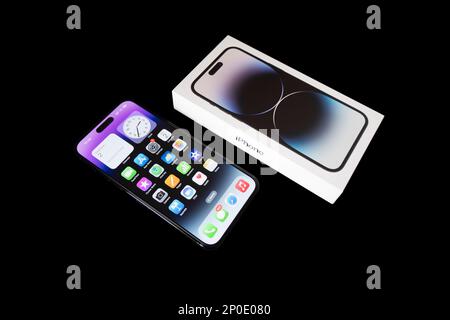Yerevan, Armenia, March 2, 2023: iPhone and package Apple iPhone 14 Pro Max standing on black table. Dynamic Island feature on display Stock Photo