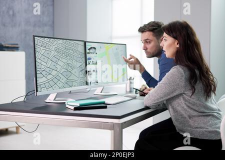 Developer Looking At Land Plot Map And Cadastre Plan Stock Photo