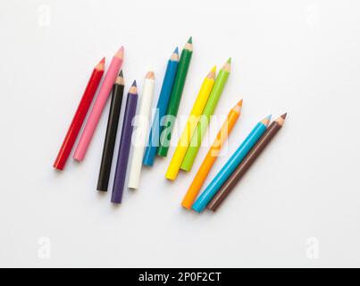 Bunch of fun mini colored pencils isolated on white. Multicolor group of cute small wooden pencils Stock Photo