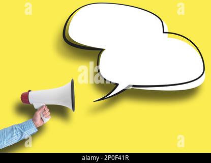 hand holding megaphone and speech bubble against yellow background, message template with copy space Stock Photo