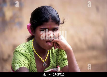 Betta Kurumba belle sitting in front of her hut, Tribal at Mudumalai