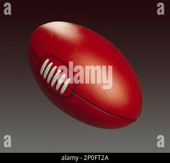 A generic unbranded aussie rules football ball on an isolated dark studio background - 3D render Stock Photo