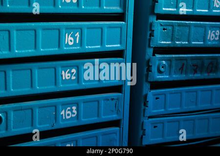 blue mailboxes in a multi-storey building Stock Photo