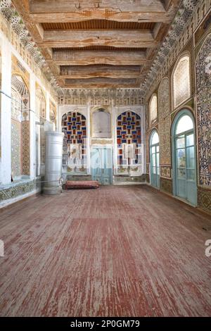 The grand reception, living room with metal, steel heater added. At an old, historic, classic, traditional, typical, iconic Jewish house in Bukhara, U Stock Photo