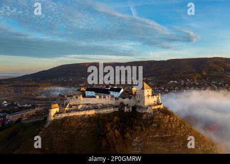 Foggy fall photo about the Fort of Sumeg Hungary. This fort is a Hungarian historical monuments. Medieval fortress. Built by King Bela IV in 13th cent Stock Photo