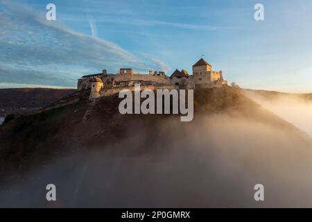 Foggy fall photo about the Fort of Sumeg Hungary. This fort is a Hungarian historical monuments. Medieval fortress. Built by King Bela IV in 13th cent Stock Photo