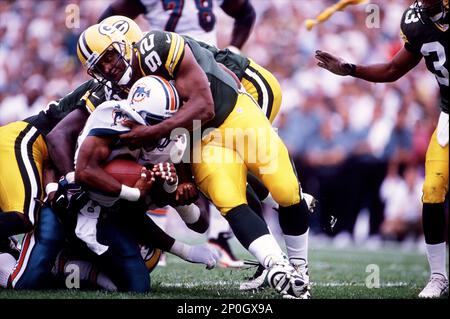 Miami Dolphins' Karim Abdul-Jabbar (33) looks up field with Pittsburgh  Steelers Willie Williams (27) in pursuit during first quarter action in  Miami Monday, Nov. 25, 1996. (AP Photo/Rick Bowmer Stock Photo - Alamy