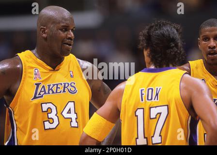 Los Angeles Lakers Kobe Bryant, left, holding the championship trophy,  celebrates with teammates Rick Fox, Lindsey Hunter, second from right, and  Shaquille O'Neal, right, holding the MVP trophy, after winning Game 4