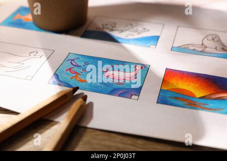 Pre Processing Cartoon Storyboard with cartoon sketches at workplace, closeup. Pre-production ...