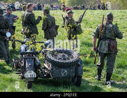 Reenactors in uniforms of Waffen-SS German troops, BMW R-71, 1939 German motorcycle with a sidecar, at reenactment of WW2 battle, Jelenia Gora, Lower Silesia, Poland Stock Photo