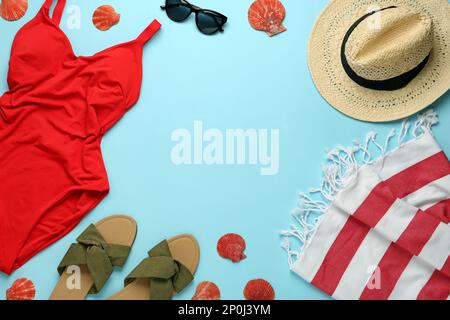 Frame made with different beach objects on light blue background, flat lay. Space for text Stock Photo
