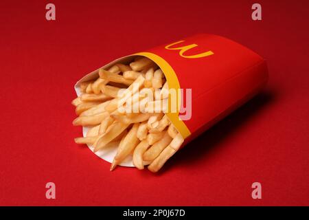 MYKOLAIV, UKRAINE - AUGUST 12, 2021: Big portion of McDonald's French fries on red background Stock Photo