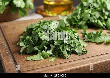 Chopped cilantro on wooden board close-up Stock Photo by ©belchonock  44324281