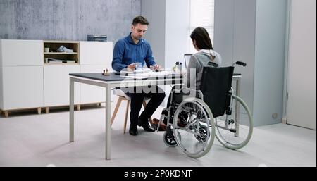 Businesswoman ith Disability Sitting On Wheelchair In Office Stock Photo