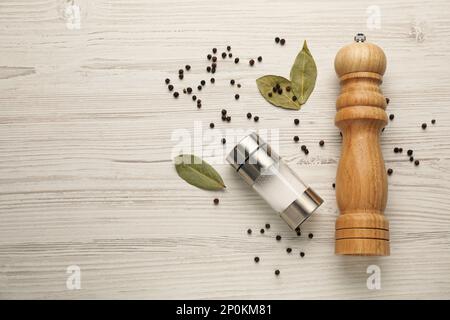 https://l450v.alamy.com/450v/2p0km81/salt-and-pepper-shakers-with-bay-leaves-on-white-wooden-table-flat-lay-space-for-text-2p0km81.jpg