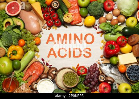 Different natural food on white wooden table, flat lay. Sources of essential amino acids Stock Photo