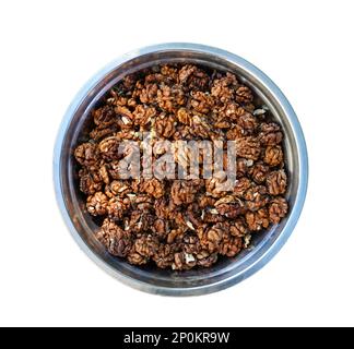 Shelled walnuts in a metal bowl on white background. Close-up, from above, isolated macro food Stock Photo