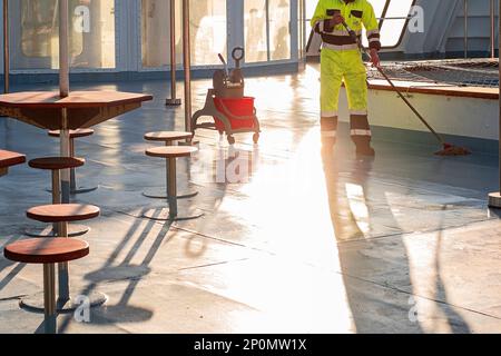 Cleaning and mopping floors on a cruise ship Stock Photo