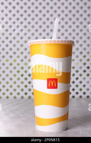 MYKOLAIV, UKRAINE - AUGUST 12, 2021: Cold McDonald's drink on grey table Stock Photo