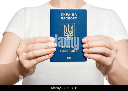 Unrecognizable woman holding Ukraine passport with both hands in front of her chest. Stock Photo