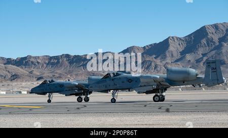 Two A-10C Thunderbolt IIs, assigned to the 354th Fighter Generation Squadron, prepare for take off as part of Red-Flag at Nellis Air Force Base, Nevada, Jan. 24, 2023. Participants conducting training missions during Red Flag-Nellis 23-1 are able to test and perfect Agile Combat Employment operating concept for how the U.S. combat forces will fight in a modern, contested environment. Stock Photo