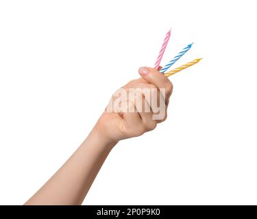 Small multi-colored candles in a female hand, isolate. Birthday candles. Stock Photo