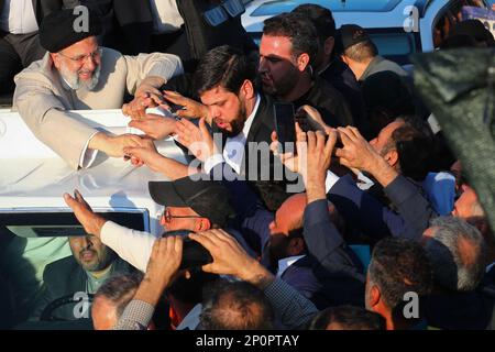 Bushehr, Bushehr, Iran. 2nd Mar, 2023. This handout picture provided by the Iranian presidency shows President EBRAHIM RAISI greeted by crowds in Bushehr, Iran. Stating that the enemy does not want the Iranian nation to live independently, freely, with strong will and cohesion, the President said, The enemy has always tried to stop or at least slow down the Iranian nation's rapid movement with Imposed War, sedition of hypocrites, and malicious threats and sanctions. Still, it has not succeeded and will not succeed. (Credit Image: © Iranian Presidency via ZUMA Press Wire) EDITORIAL USAGE ONLY! Stock Photo