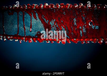 chainsaw stained with blood dark background Stock Photo