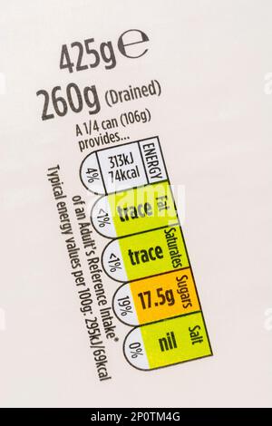 Food nutrition traffic-lights strip on paper label of Morrison's own label tinned pineapple. For UK food dietary information & nutritional labelling. Stock Photo