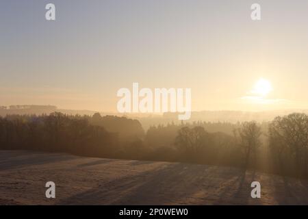 Sunrise over a frost covered countryside landscape Stock Photo