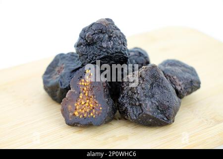 Cut dried figs on wooden background close-up. Stock Photo