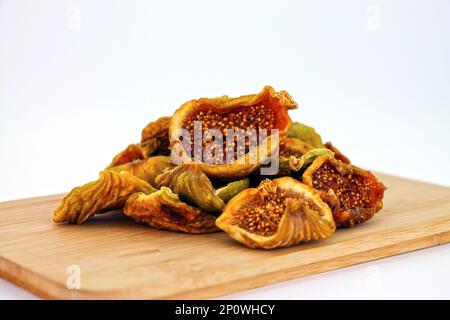 Cut dried figs on wooden background close-up. Stock Photo