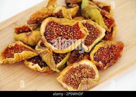 Cut dried figs on wooden background close-up. Stock Photo